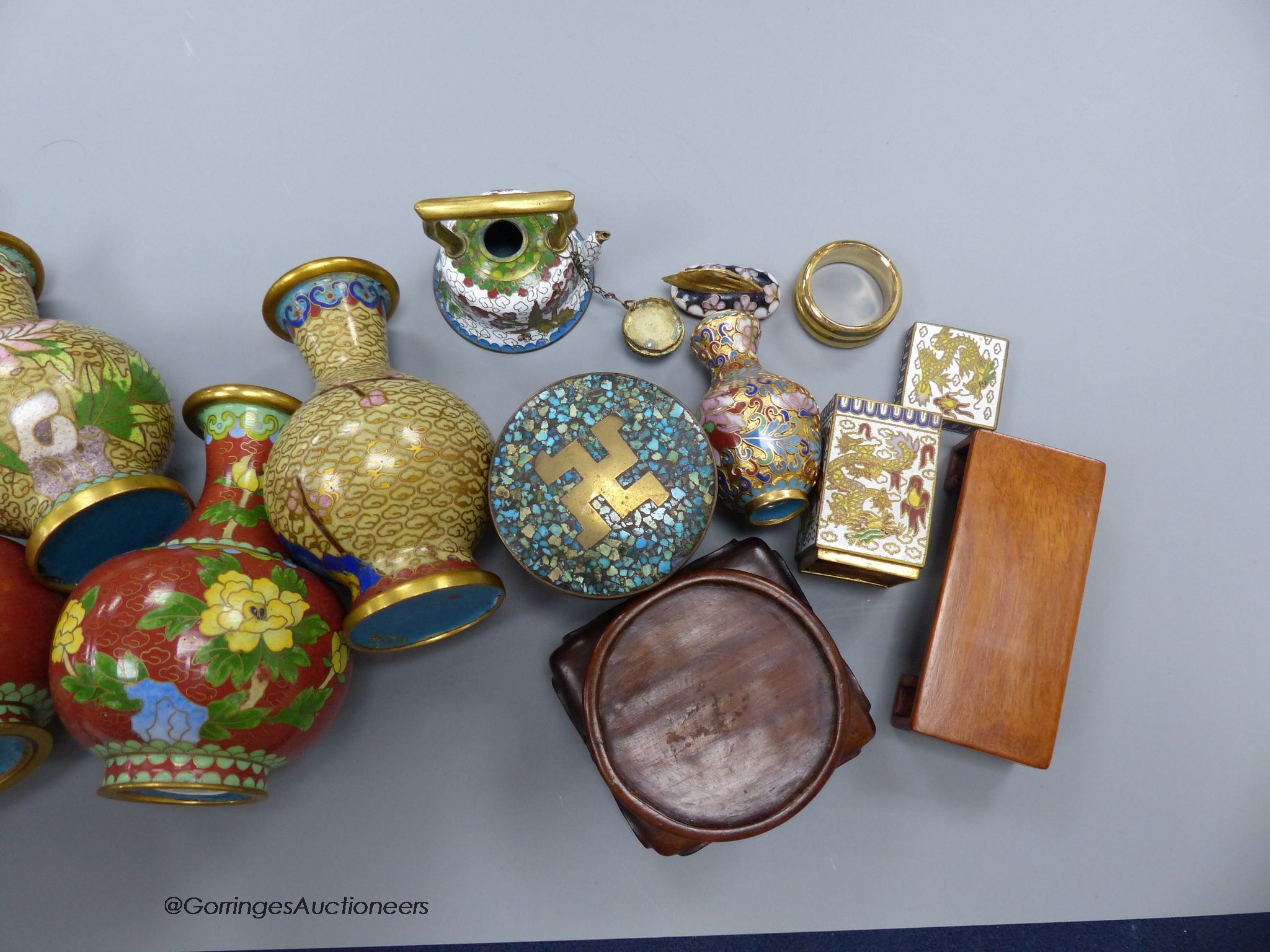 A group of Chinese or Japanese wood stands and cloisonne enamel vases